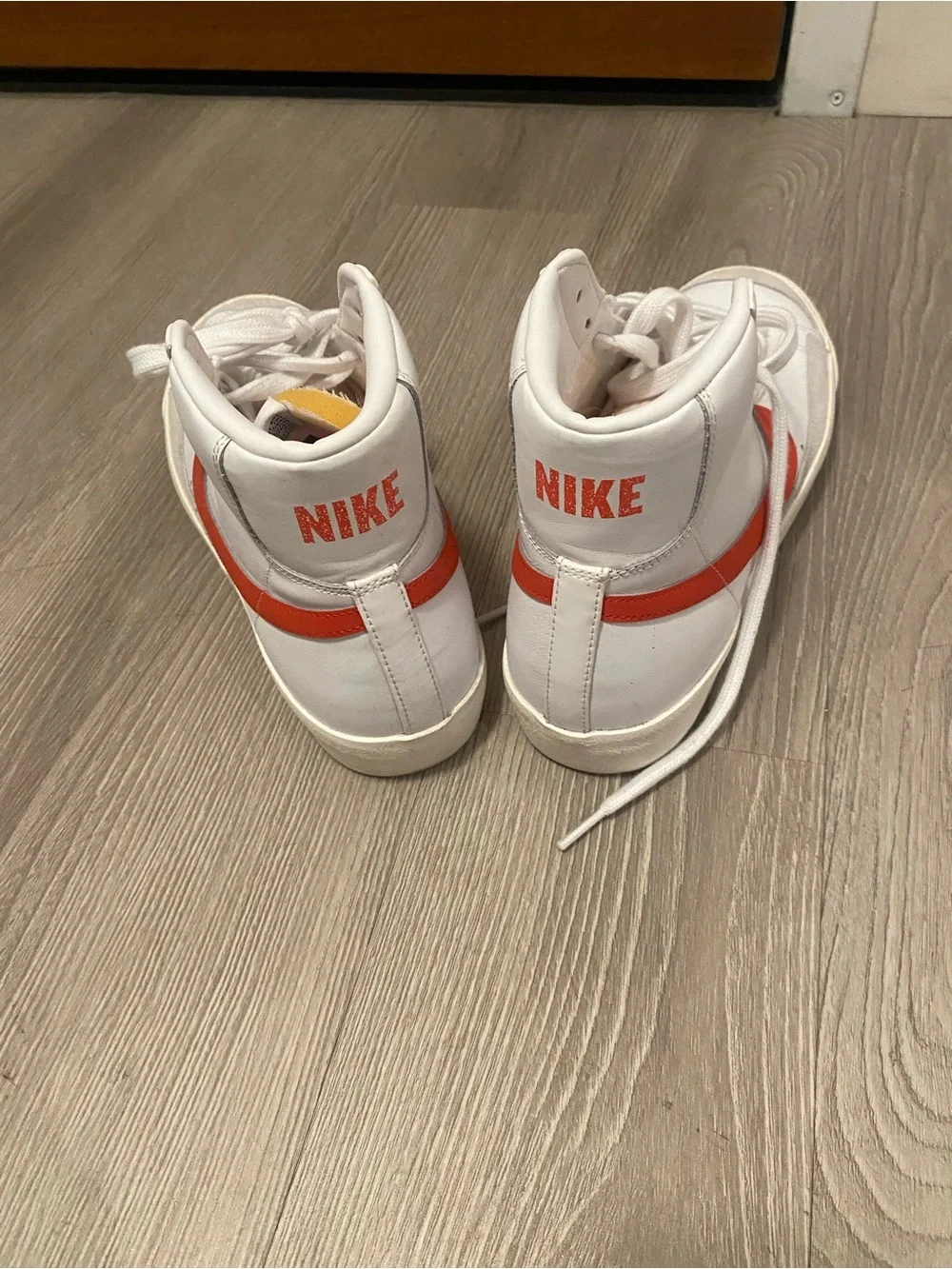 Nike White High-Top Sneakers with Red Swoosh Accent